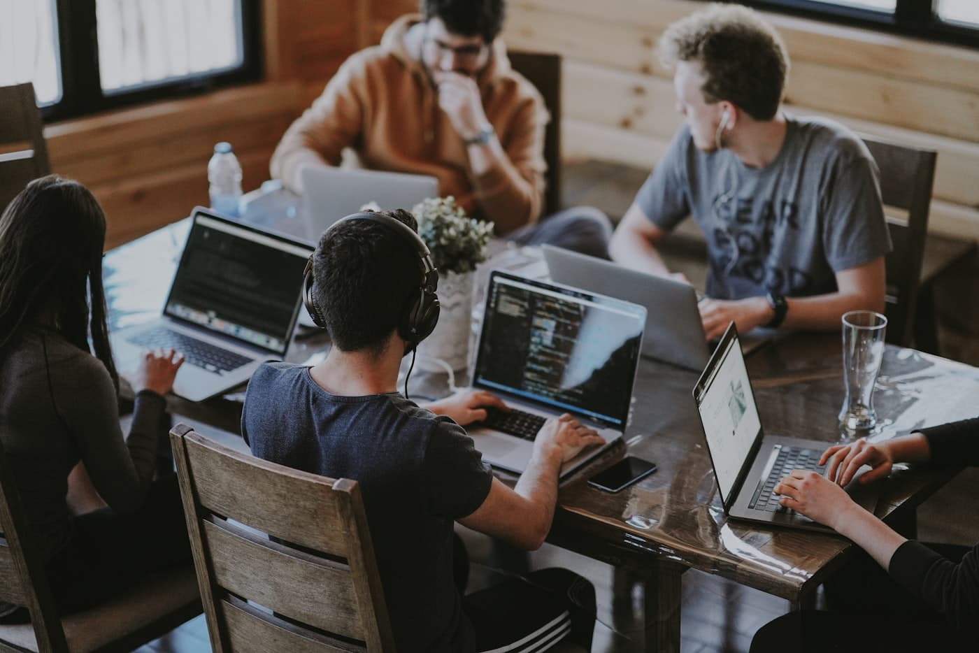 A team working together around a laptop